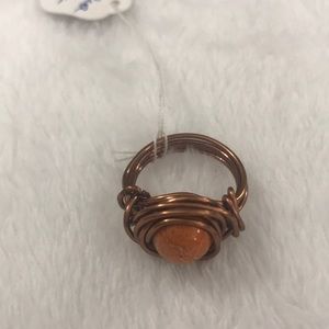 Bronze wired ring with orange bead inside